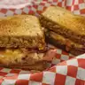 Pastrami Reuben — Pastrami, sauerkraut, thousand island, dijon, swiss cheese on light rye